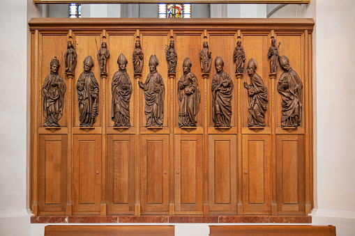 Panel with figures of priests carved in wood in the Frauenkirche or The Church of Our Beloved Lady which is the cathedral in Munich and is originally build in 1494 but has been partly rebuild after World War II.