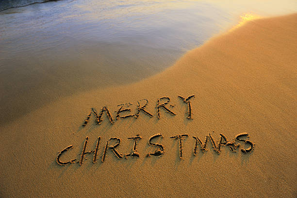 istock Merry Christmas handwritten in sand on a beautiful beach 136220967