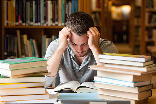 istock Tired student having a lot to read 136221090