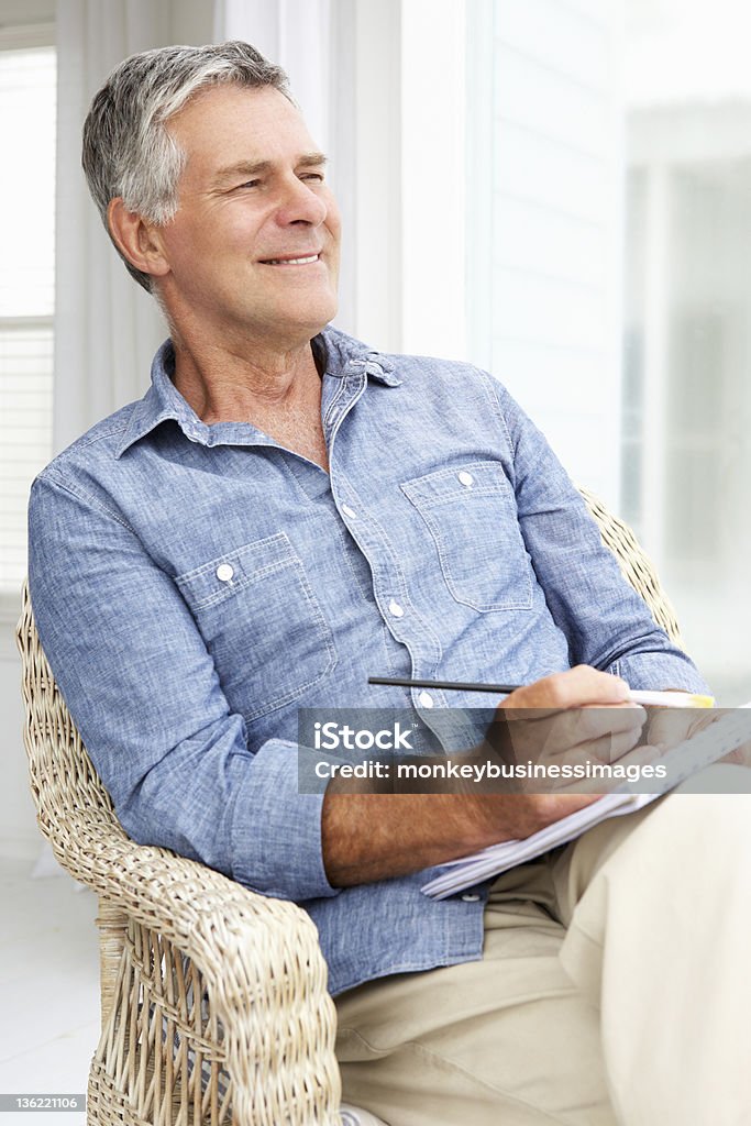Senior man sketching Senior man sitting on porch sketching 60-69 Years Stock Photo