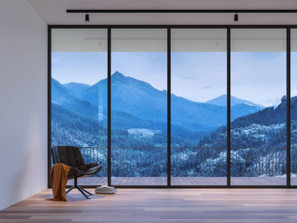 Modern style living room with winter view 3d render,There are wood floor,white wall decorate with black leather chair,The room has large windows. Looking out to see the view of mountain and snow.