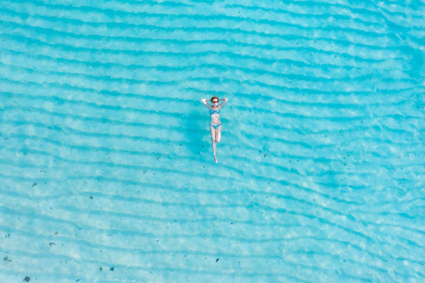 istock Woman lying back on crystal water 1362220344