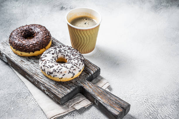 istock Fresh Chocolate artisan donuts and take away coffee. White background. Top view. Copy space 1362220382