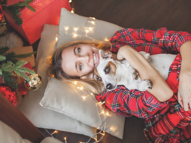 istock Happy woman on Christmas tree background 1362221292
