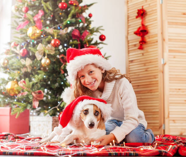 istock Child with dog near christmas tree 1362221307