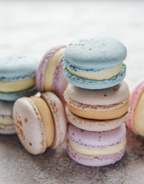 istock Beautiful colorful tasty macaroons on a concrete background 1362223710