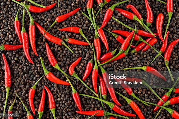 Red Peppers On Black Peppercorns Stock Photo - Download Image Now - Backgrounds, Brown, Burning