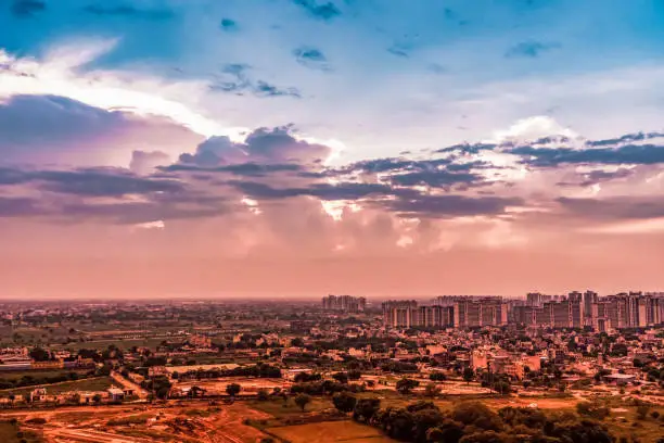 Gurugram India, developing infrastructure set in the backdrop of dramatic clouds. Dramatic Growth