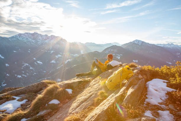 istock Hiker uses digital tablet on mountain summit 1362227793