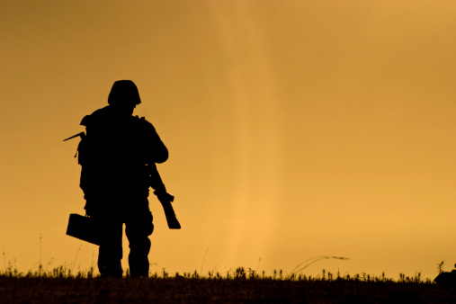 Isolated soldier against a sunset.