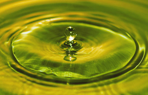 Oil Drop Motion Capture Drop of oil suspended above surface ripples heating oil photos stock pictures, royalty-free photos & images