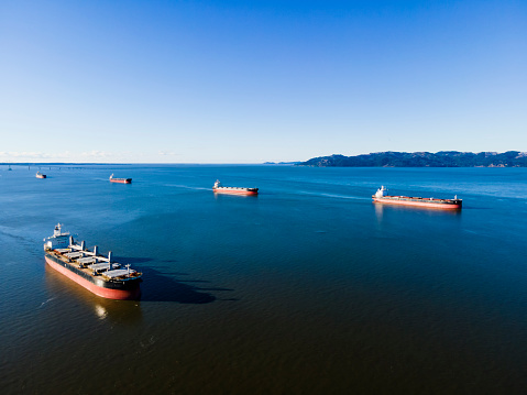 Astoria bay, Or, filled with shipping freighters waiting to transit up the Columbia river, to load up cargo. shot on December 31, 2021