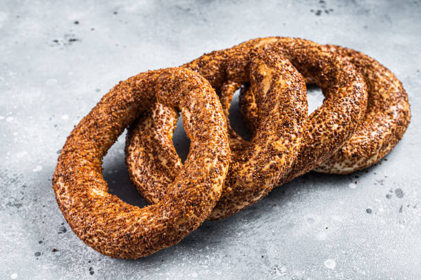 istock Turkish Bagel Simit with sesame traditional pastry. Gray background. Top view 1362234310