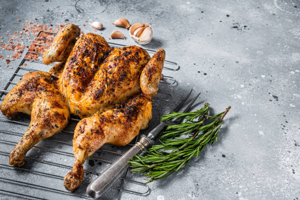 istock Traditional spatchcocked barbecue chicken on grill. Gray background. Top view. Copy space 1362234334