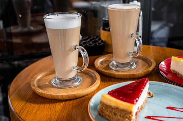 istock Classic New York Cheesecake And Coffee Latte on a table in cafe. Top view 1362235449
