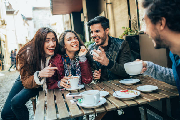 istock Friends talking and laughing in a cafe 1362238378