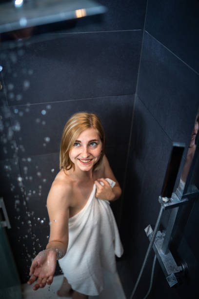 istock Pretty, young woman taking a long hot shower 1362239006