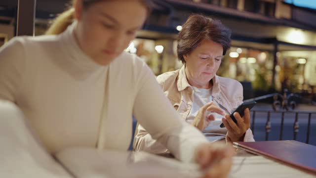 Mother and daughter checking menu at restaurant