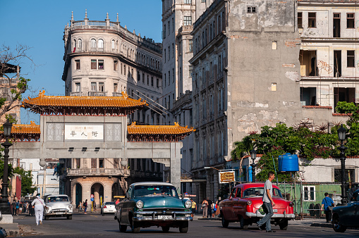 Classic car traffic on an avenue that leads to the entrance of the Chinese neighborhood in Old Havana. Havana Cuba. May 12, 2015.