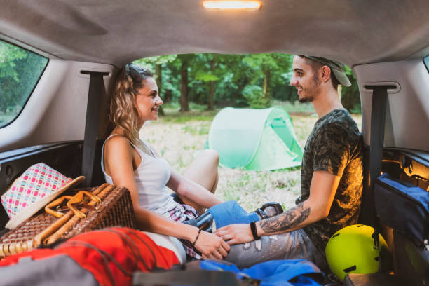 istock Young couple at road trip with car 1362244943
