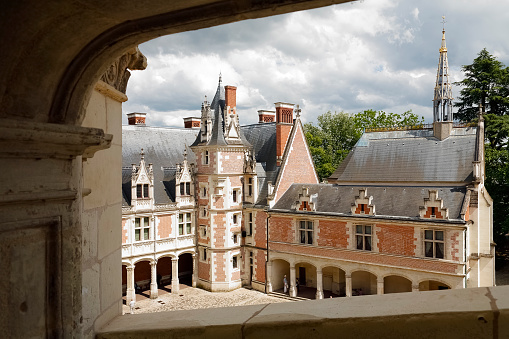 Blois, France - June 11, 2010: The inner facade of the Blois Castle as seen from the side of the courtyard. Blois Royal Castle is a historical monument, which is a wonderful mixture of art and history. It is one of the countless great tourist destinations, being a significant tourist attraction, is often and numerously visited by many tourists from all over the world.