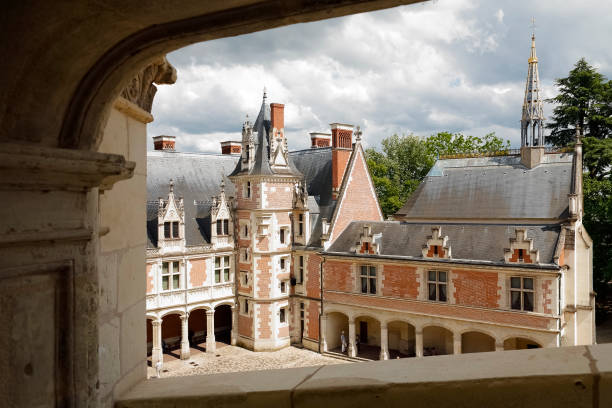 Blois Royal Castle in the Loire Valley, France Blois, France - June 11, 2010: The inner facade of the Blois Castle as seen from the side of the courtyard. Blois Royal Castle is a historical monument, which is a wonderful mixture of art and history. It is one of the countless great tourist destinations, being a significant tourist attraction, is often and numerously visited by many tourists from all over the world. blois stock pictures, royalty-free photos & images