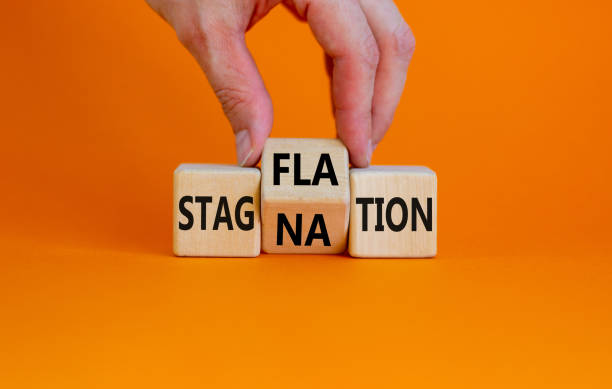 istock Stagflation or stagnation symbol. Businessman turns cubes, changes the word stagnation to stagflation. Beautiful orange background, copy space. Business, stagflation or stagnation concept. 1362246003