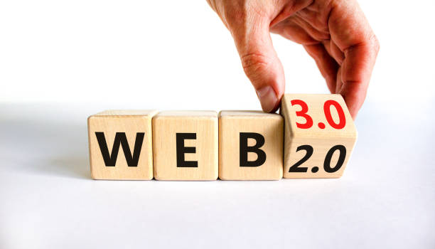 WEB 2.0 or 3.0 symbol. Businessman turns a wooden cube and changes words WEB 2.0 to WEB 3.0. Beautiful white table, white background, copy space. Business, technology and WEB 2.0 or 3.0 concept. stock photo