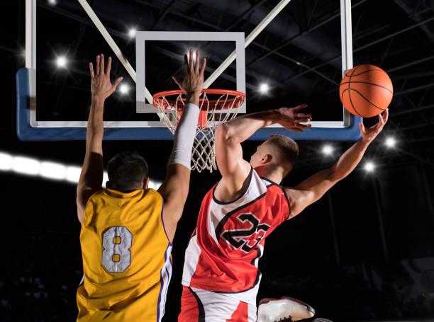 Two basketball players in action Two basketball players in action in gym basketball sport stock pictures, royalty-free photos & images