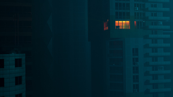 Digitally generated image of city buildings  at night. The city is dark except for one apartment where light shines.