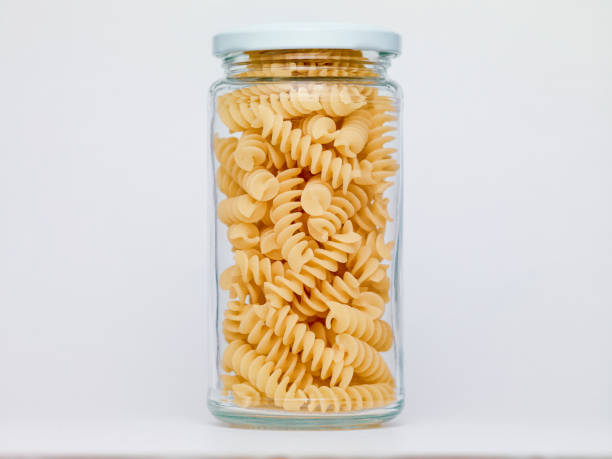 istock Pasta in glass jar on a white background 1362260365