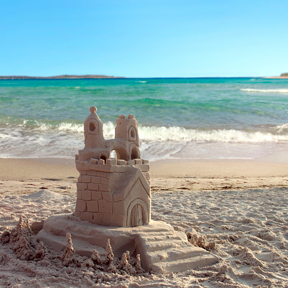 Mermaid made of sand and shells on the beach.