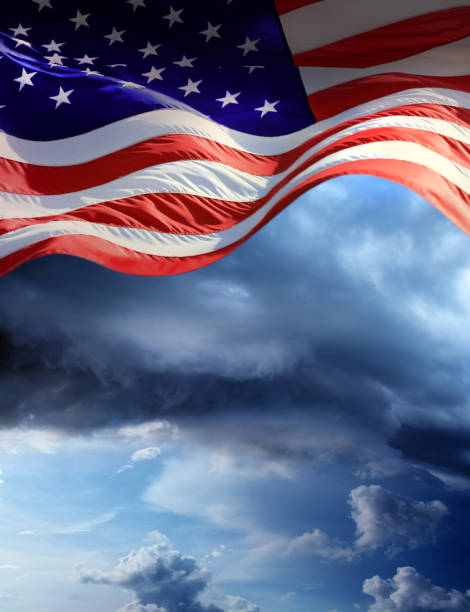 istock Close up waving American flag over stormy dramatic sky 1362262622