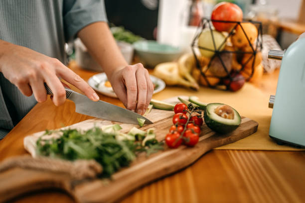 istock Woman cutting avocado slices in kitchen 1362263367