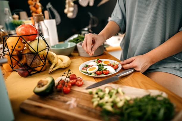 istock Woman adding seasoning to healthy breakfast 1362263375