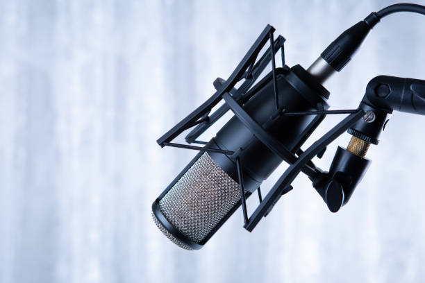 istock studio black condenser microphone against gray curtains 1362263474