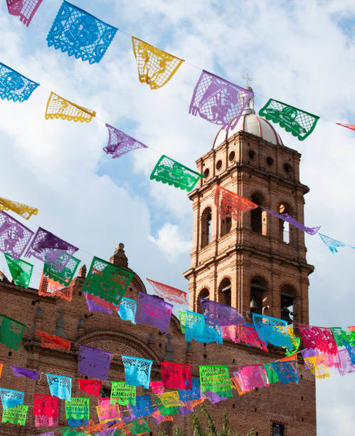 Tapalpa church with garlands The new church in Tapalpa, Jalisco, with colorful banners of papel picado in the foreground, left over from the Dia de Muertos celebration. all hallows by the tower stock pictures, royalty-free photos & images