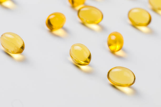 に適した油充填カプセルのクローズアップ:魚油、オメガ3、オメガ6、オメガ9、ビタミンa、ビタミンd、ビタミンd3、ビタミンe - vitamin pill capsule vitamin e fish oil ストックフォトと画像