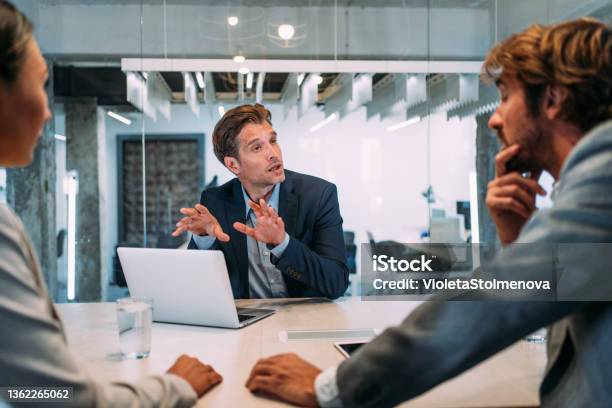 Group Of Business Persons Talking In The Office Stock Photo - Download Image Now - Advice, Lawyer, Financial Advisor