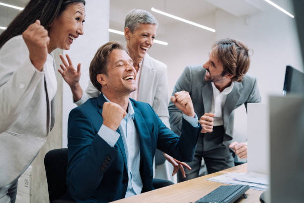 istock Cheerful entrepreneurs celebrating success in the office. 1362265065