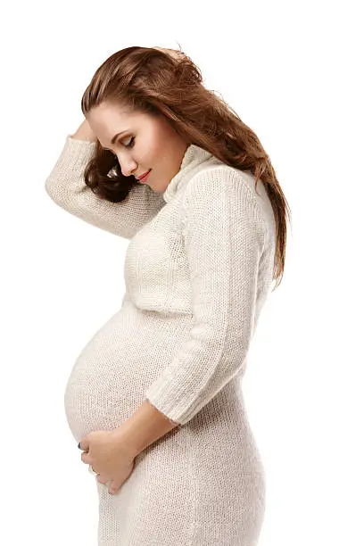 Portrait of beautiful pregnant young woman over isolated white