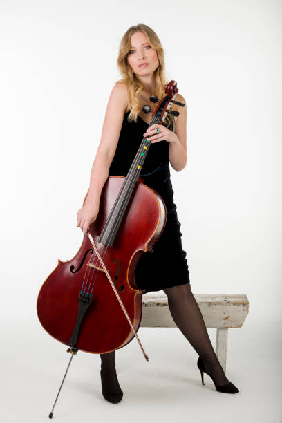 istock The viloncellist with her cello 1362266051