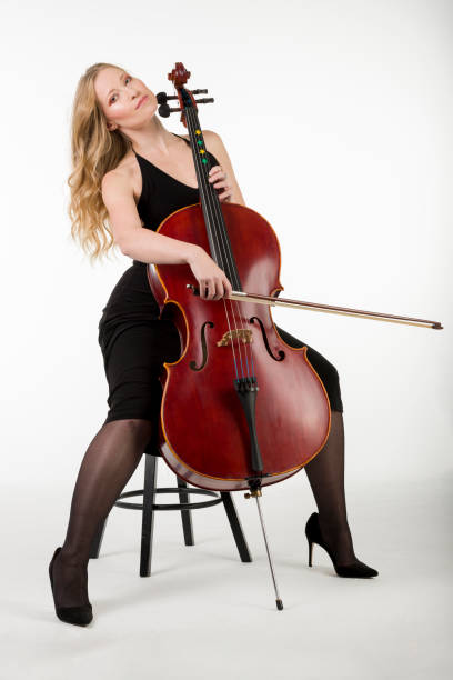 istock The viloncellist with her cello 1362266066