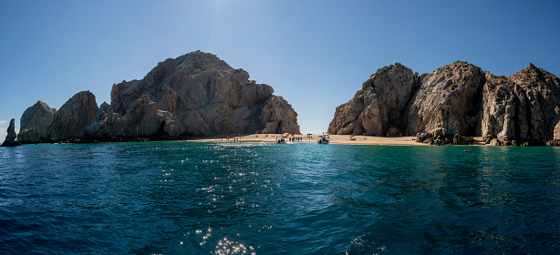 Sea Level Panoramic of cliffs arches and beaches in Cabo San Lucas Baja California Sur Mexico on a late afternoon at the convergence of the sea of cortez and the pacific ocean