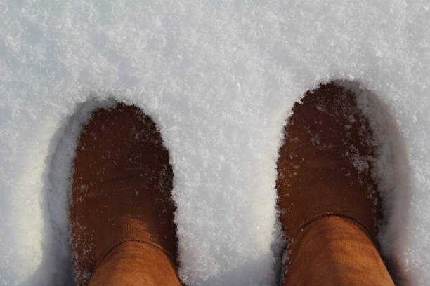 istock close-up of warm boots, ugg boots in the snow 1362267749