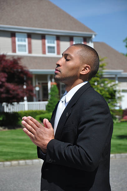 istock Young Businessman with Praying Hands 136226836