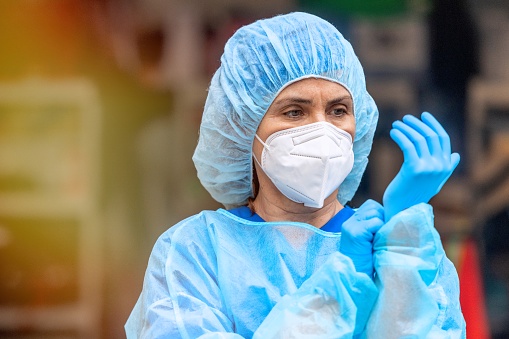 Female Healthcare worker wearing a protective face mask