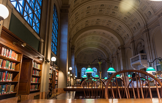 Boston, USA - December 23, 2021: View of people studying at the Reading Room of McKim Building, at Boston Public Library.