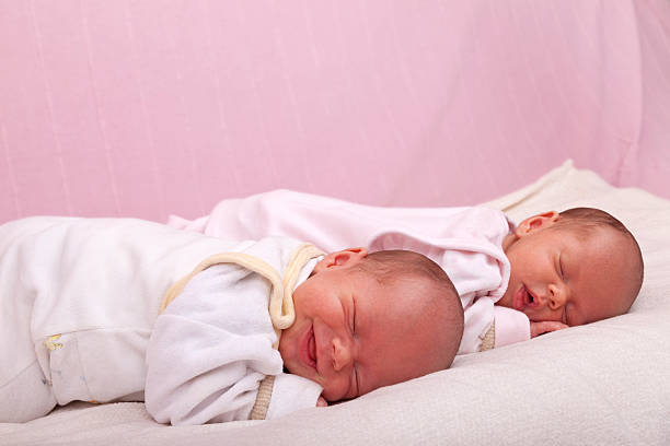 istock sleeping identical baby twin girls 136228242