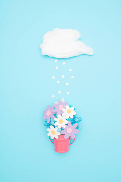 istock Summer background with rain, cloud and flowers. Springtime or love composition. 1362285642